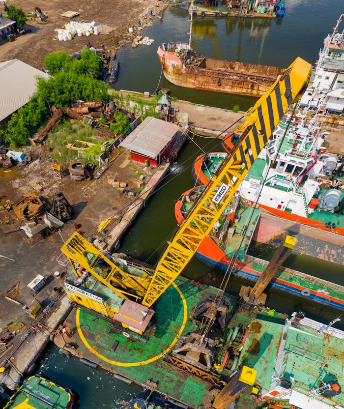 why-choose-us Aerial view of a bustling industrial dock with cranes and ships in Jakarta, Indonesia.