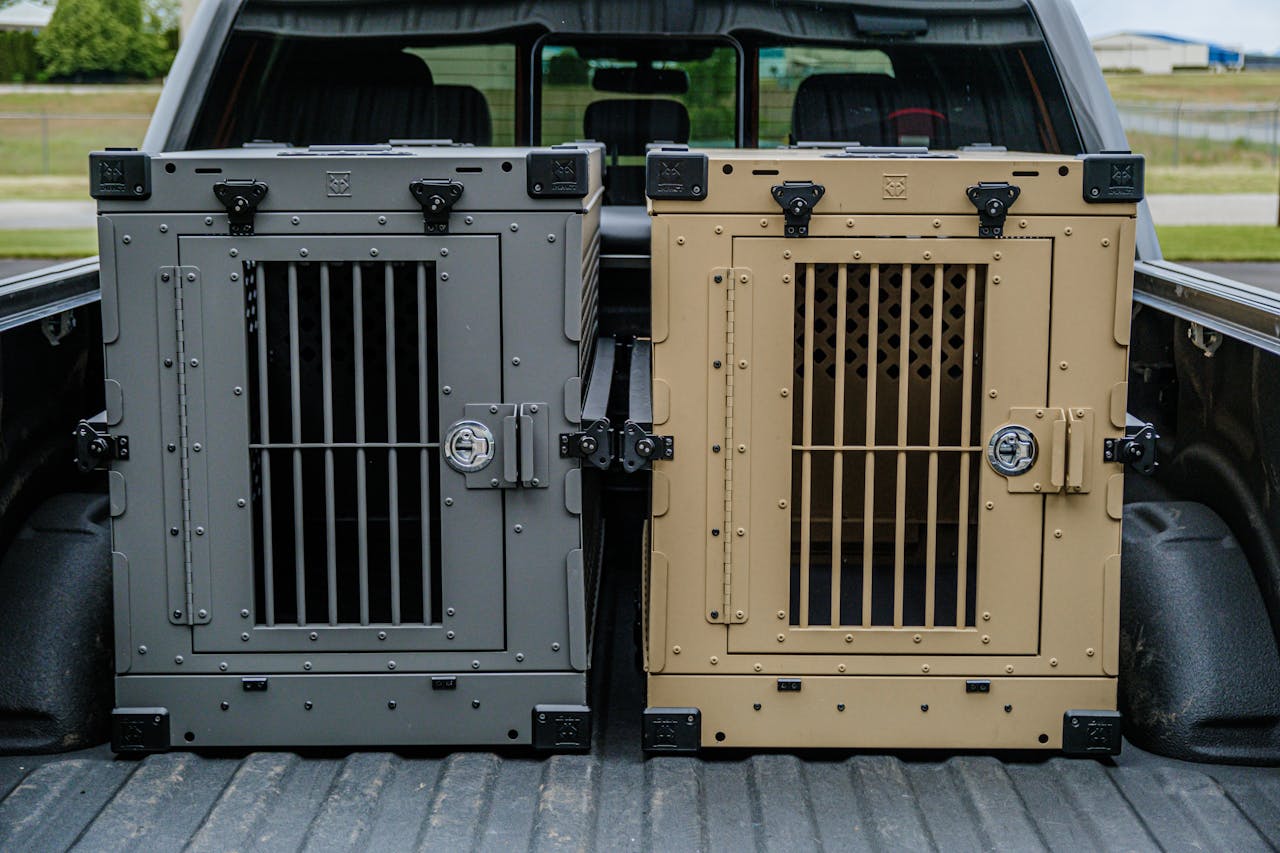 creative-03 Two premium durable dog crates in a truck bed ensuring pet safety during travel.